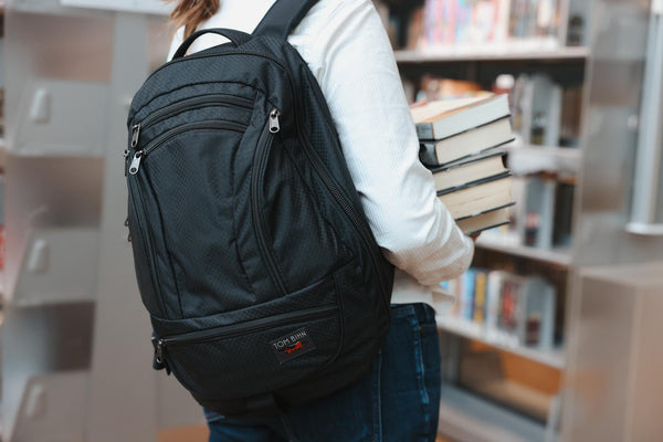 A person wearing a Spectron Synik 26 in a library